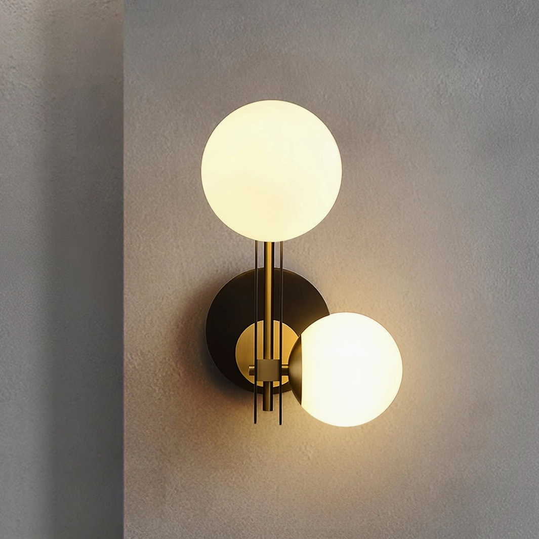Planeta black and brass wall sconce showcasing dual spherical glass shades in minimalist space