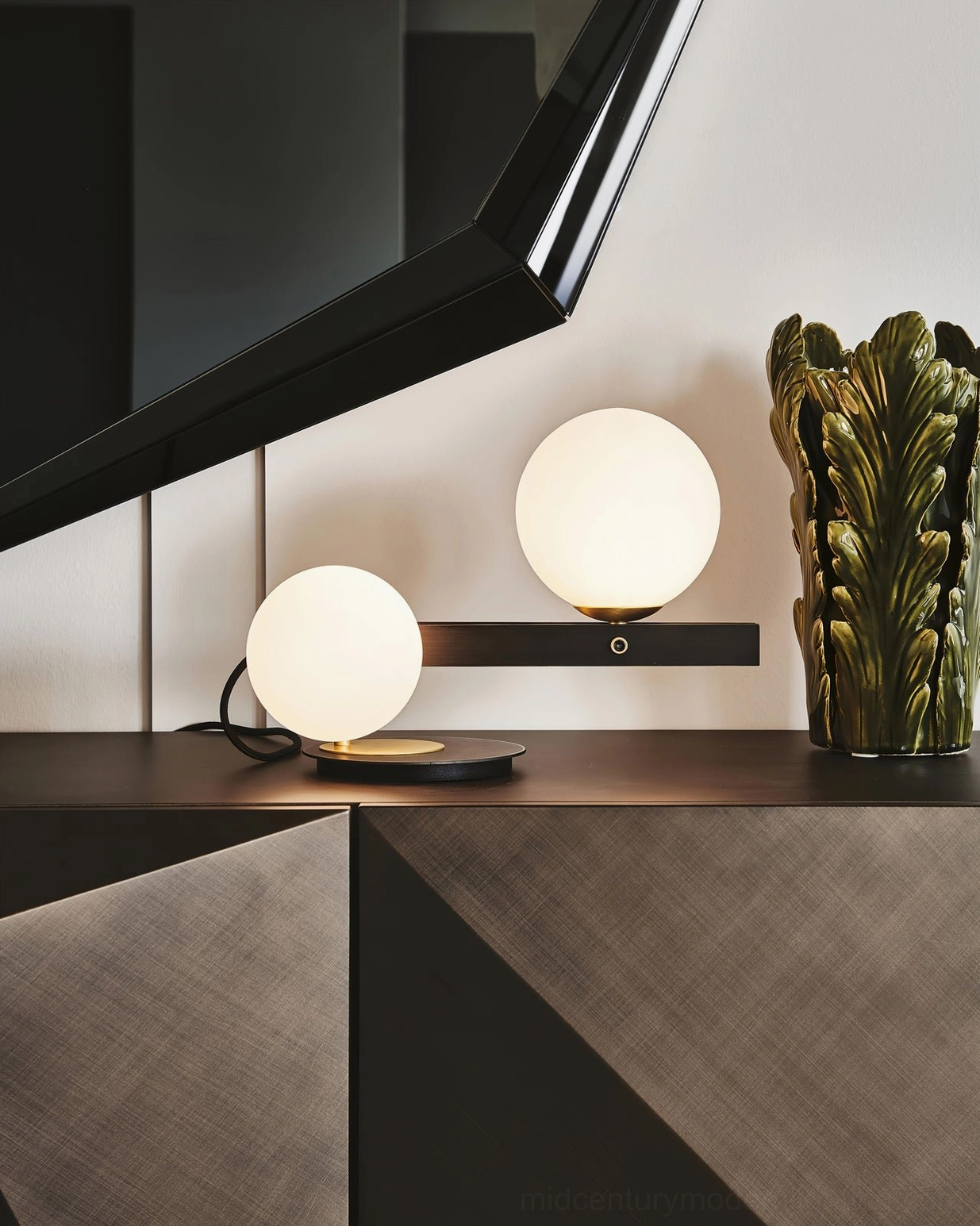Planeta dual globe decorative wall lamp on console vanity table with styling decor and plants