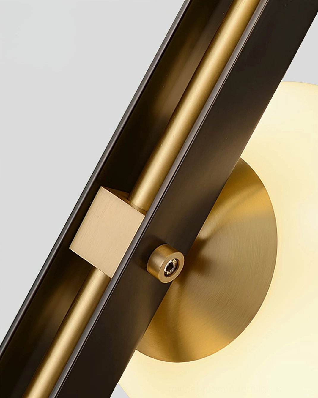 Close-up detail of Planeta floor lamp mounting joint showing brass accents and metal pole construction