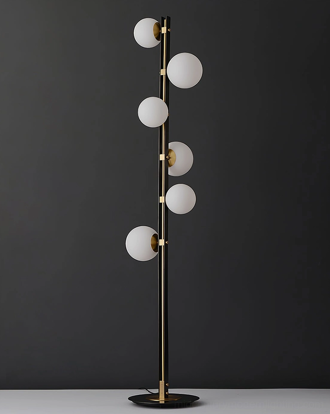 Planeta floor lamp detail shot of glass globe intersection with brass frame joints