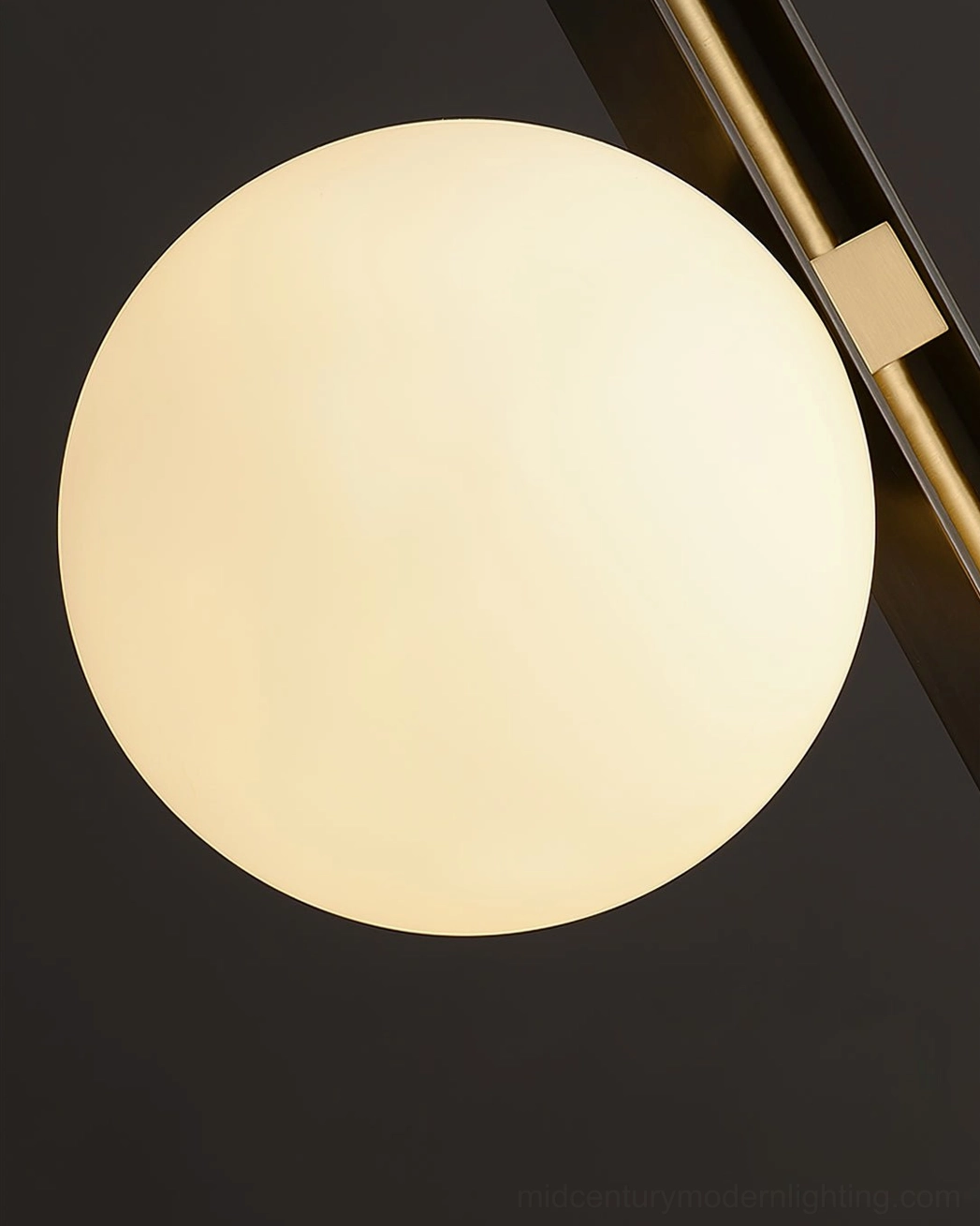 Detailed view of illuminated Planeta frosted white glass globe shade with warm interior lighting