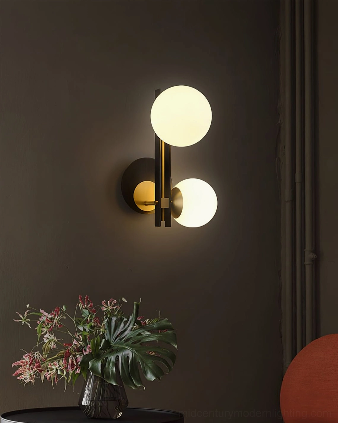 Planeta dual globe wall lamp in living room accent installation with potted plant below, modern interior design