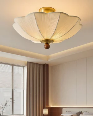 Mid-century modern pleated ceiling lamp illuminated in contemporary bedroom setting with warm light and neutral decor