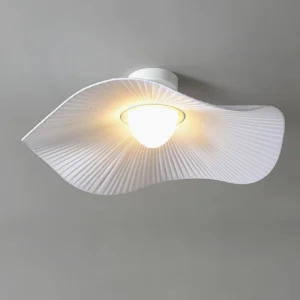 Overhead view of cloud ceiling lamp showing warm LED glow through pleated fabric texture
