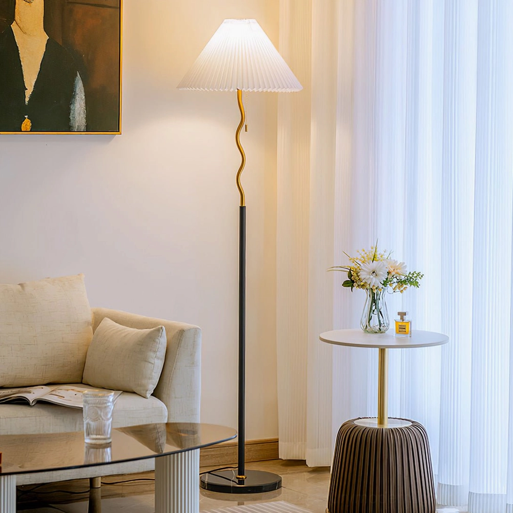 Pleated floor lamp side view in living room with sofa and side table, consistent mid-century modern design