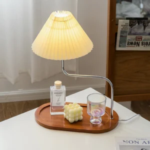 Modern table lamp with integrated walnut tray styled on bedroom nightstand with candle and perfume bottle