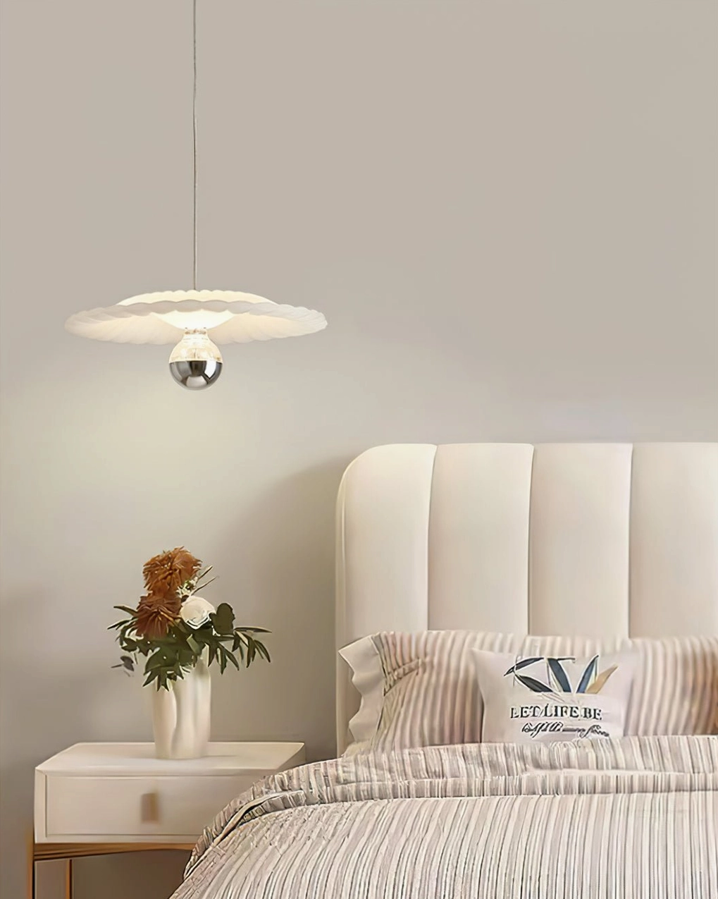 Pleated pendant lamp demonstrating geometric fabric pattern and light diffusion