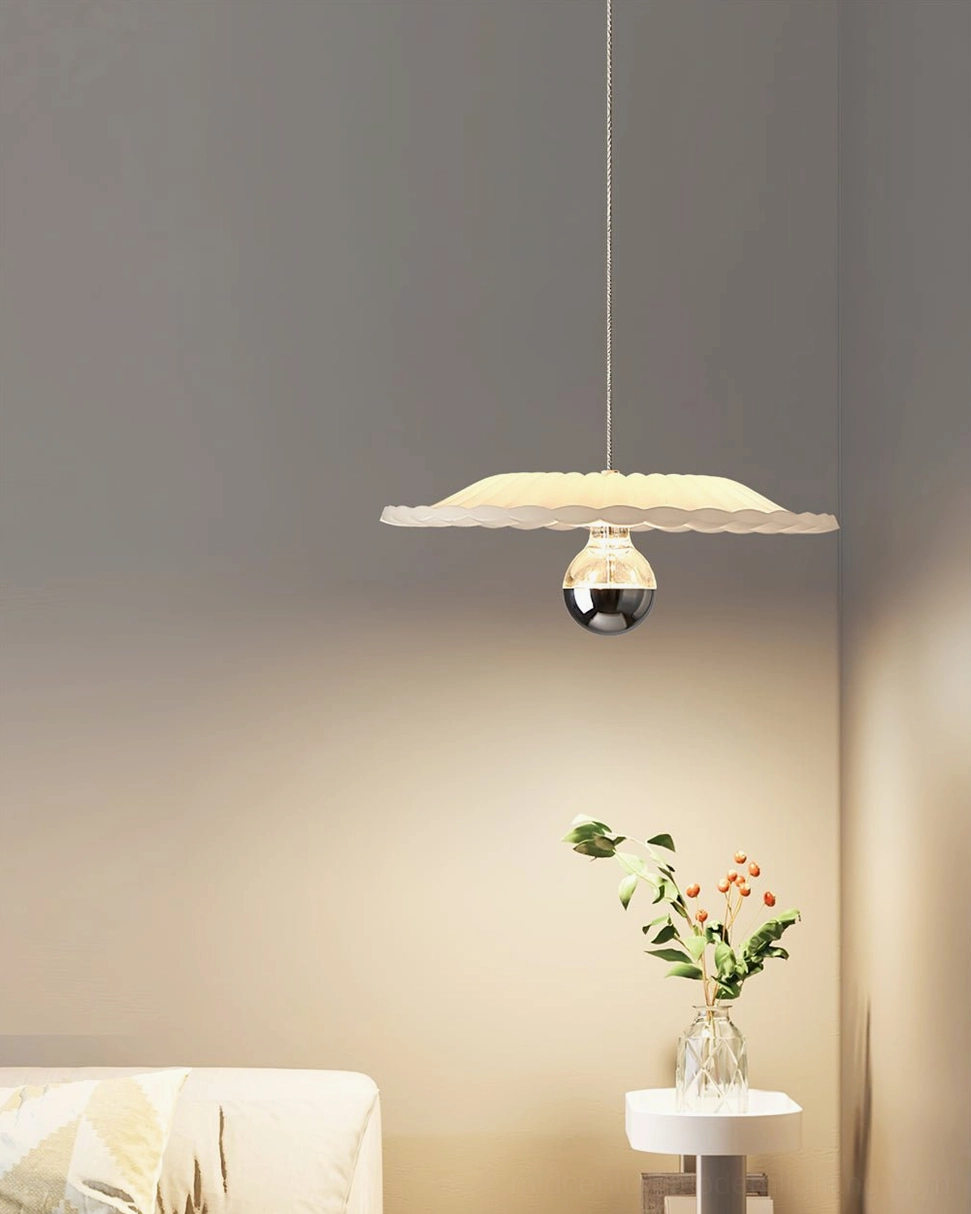 Pleated pendant light with integrated LED in cozy lounge nook with flowers and side table