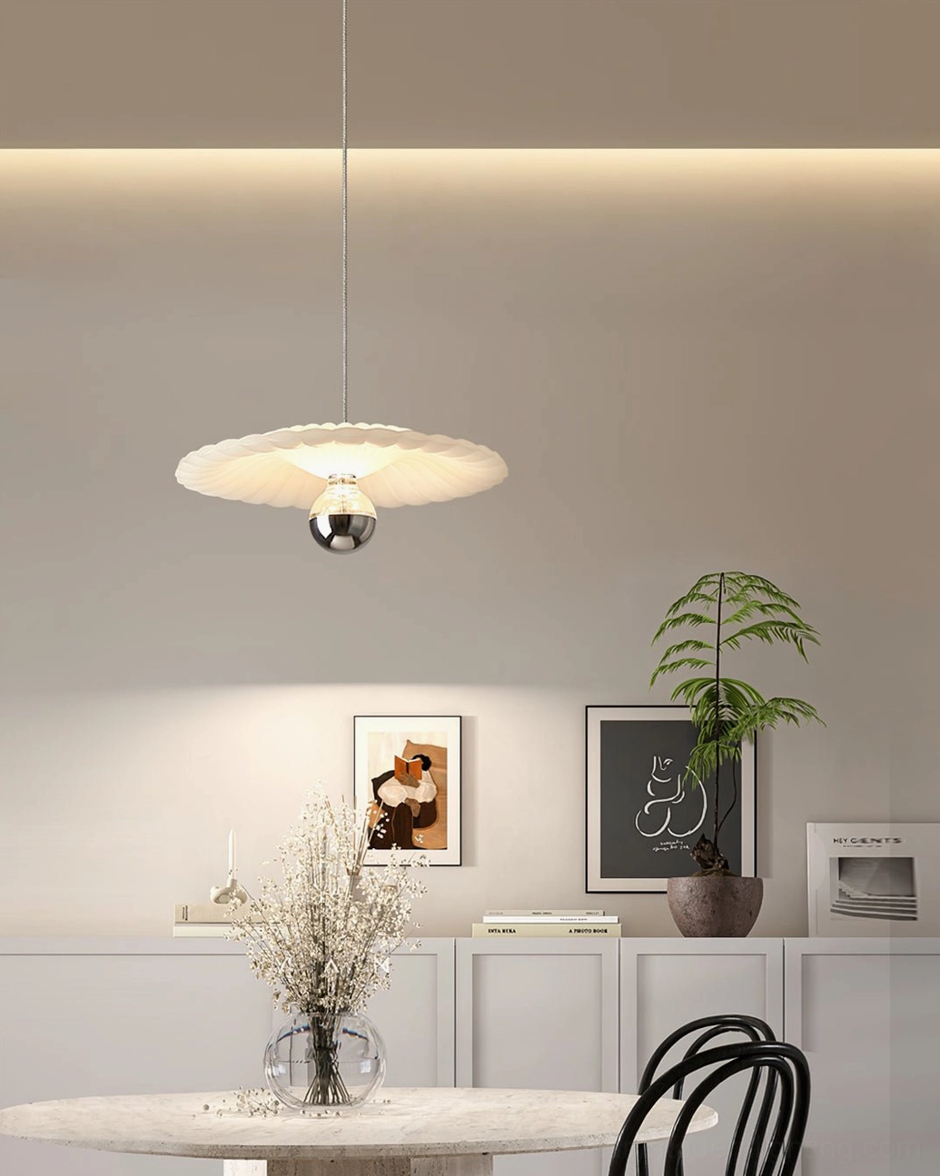 Hand-pleated pendant lamp with chrome base in minimalist living area, geometric fabric pattern