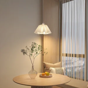 Pleated pendant lamp hanging over minimalist dining corner with warm neutral home decor and modern dining setup