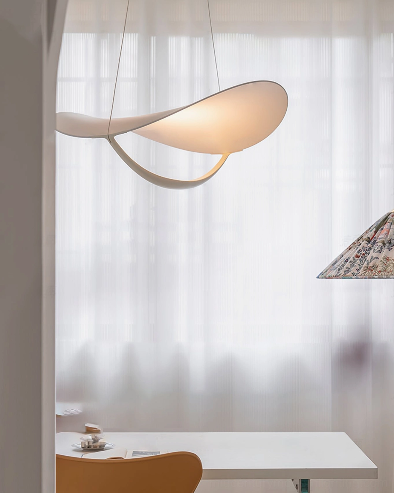 Contemporary pendant light dining nook sheer curtains soft curved design