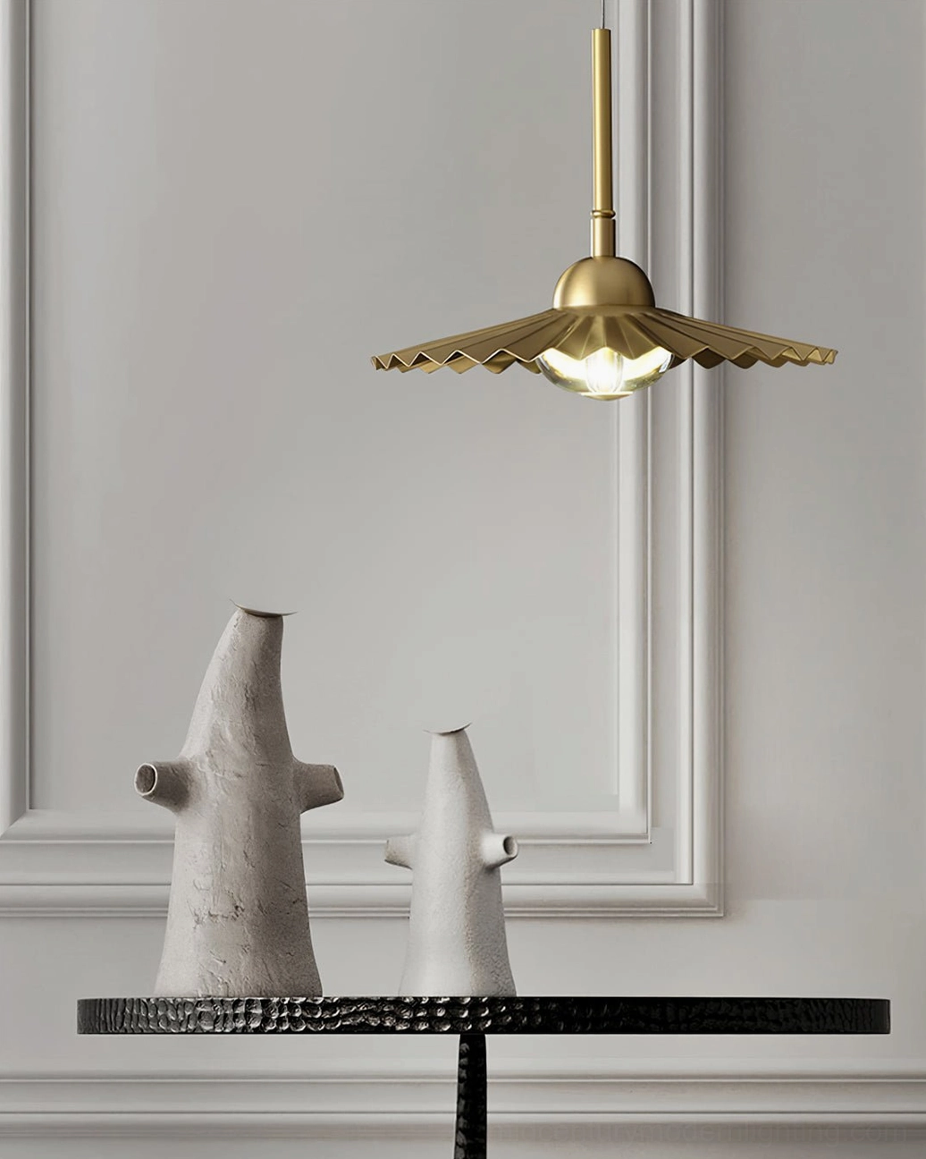 Plié brass pendant lamp creating dramatic light pattern and shadow play on ceiling and walls