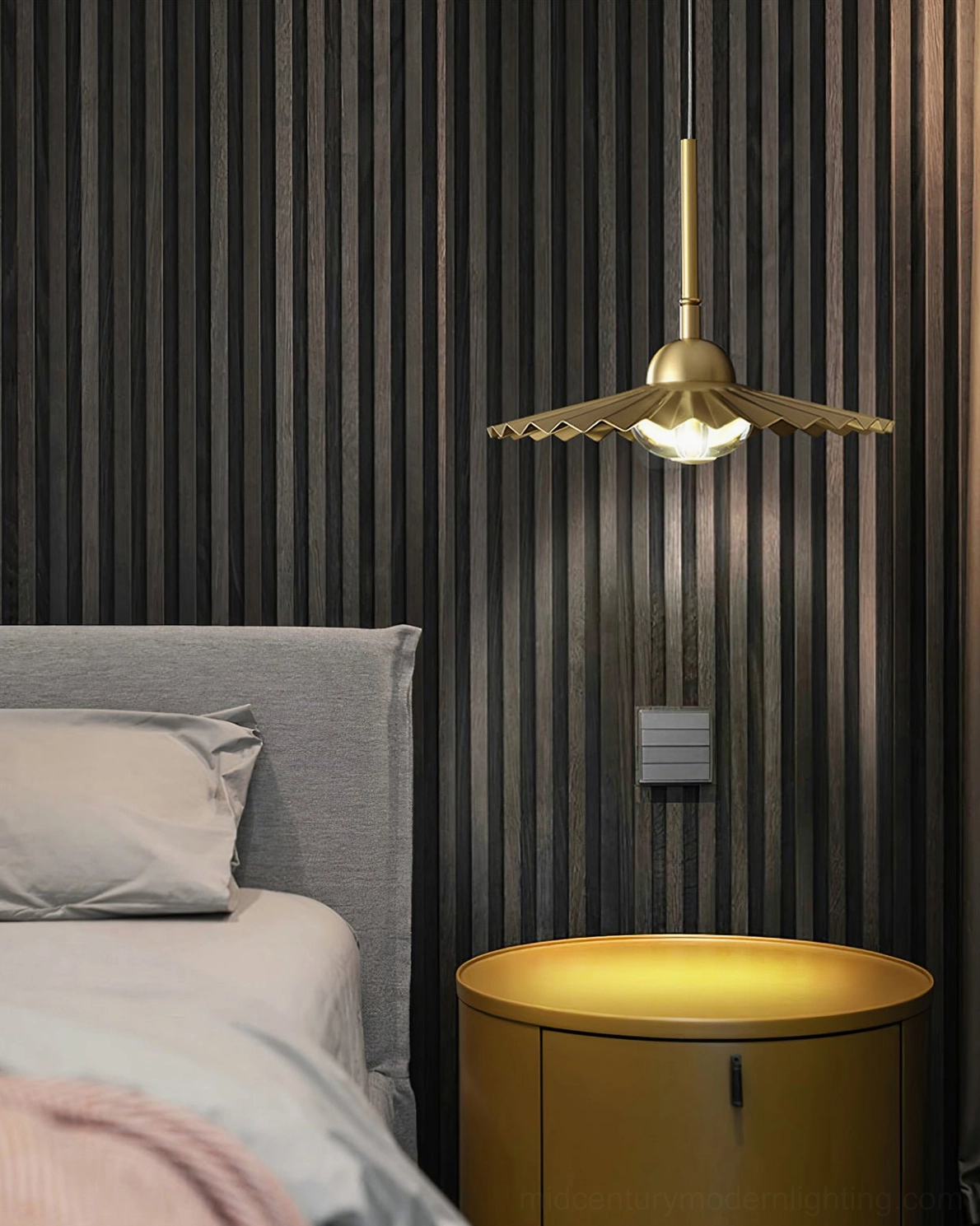 Single plié pendant suspended in modern bedroom space showcasing minimalist dark contemporary interior design aesthetic