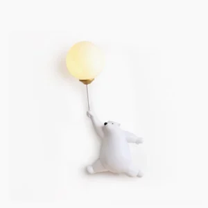 Polar bear balloon wall lamp with frosted glass shade on white studio background - modern whimsical resin sconce