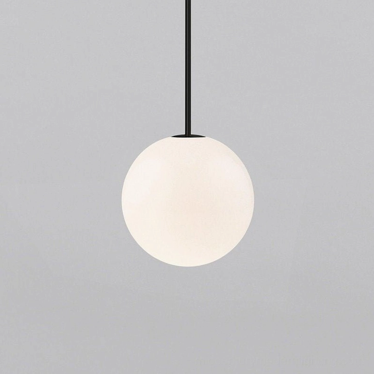 Polished brass finishing detail on suspension rod and globe pendant light fixture