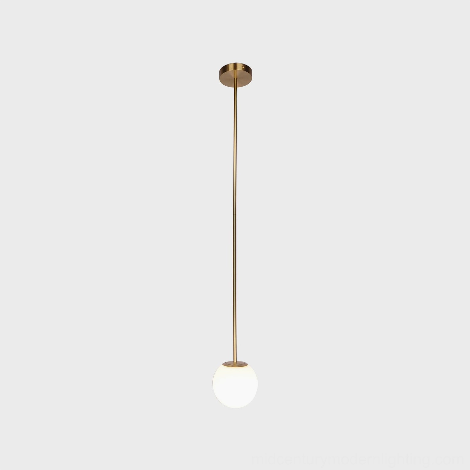 Polished brass pendant light with frosted white globe in contemporary home interior