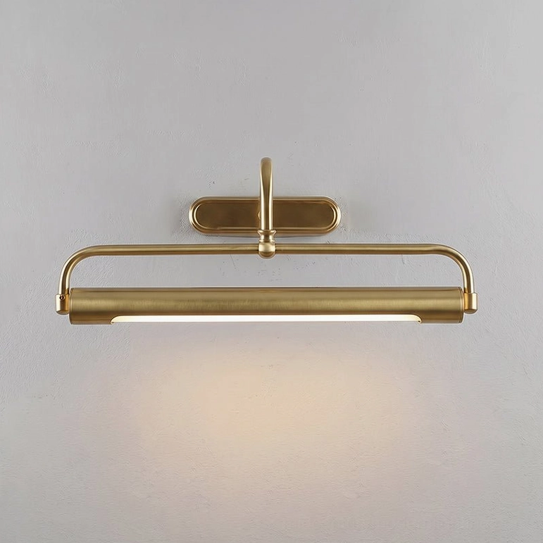 Polished brass wall sconce with oval backplate and glowing cylindrical light head
