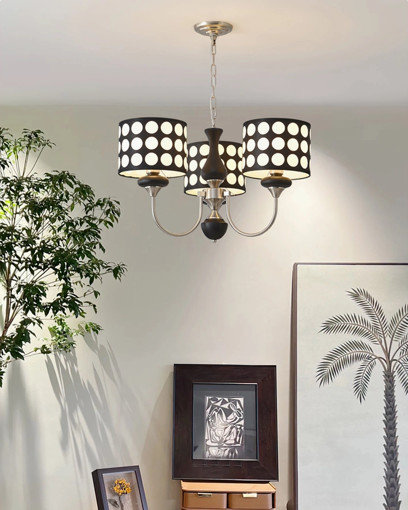 Black polka dot chandelier detail view showing metal construction and fabric shade craftsmanship