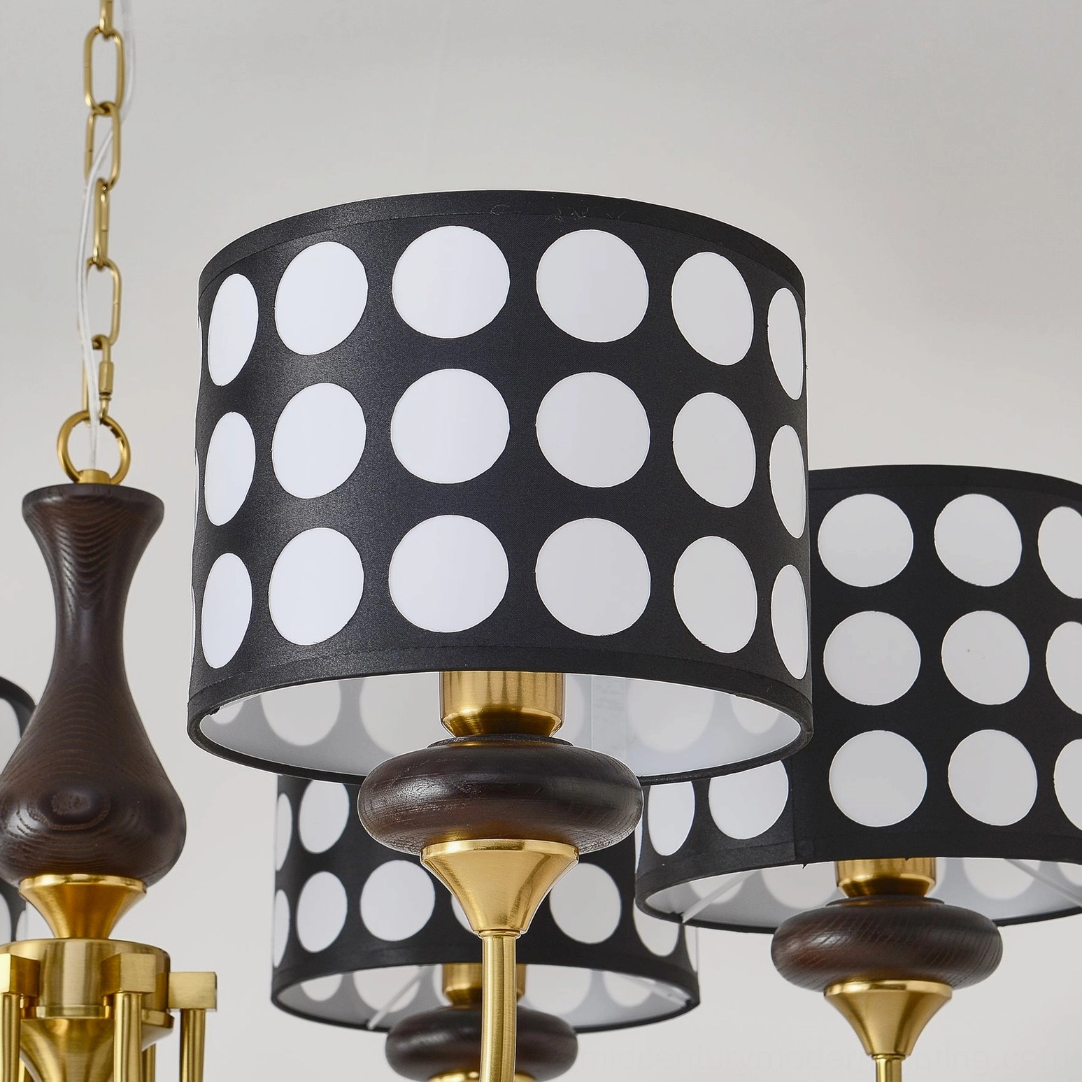 Multiple polka dot chandelier heads arranged in geometric configuration, unified design symmetry