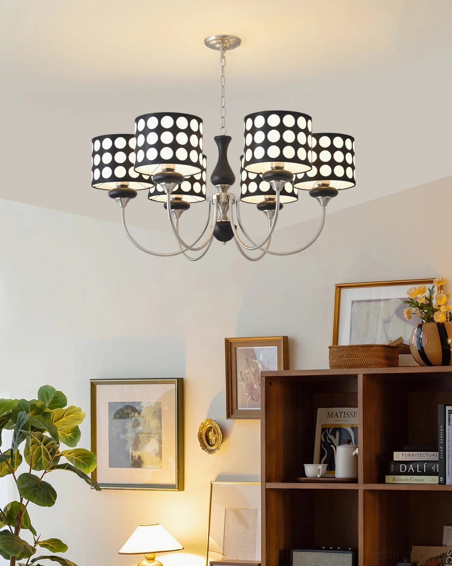 Black polka dot chandelier with silver frame and walnut wood middle decoration, warm bookshelf background