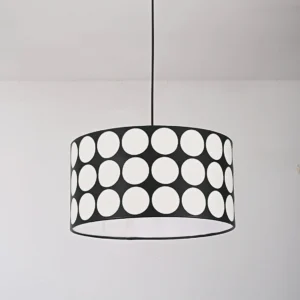 Polka dot pendant lamp viewed from below showing hollow white circle pattern on black metal frame