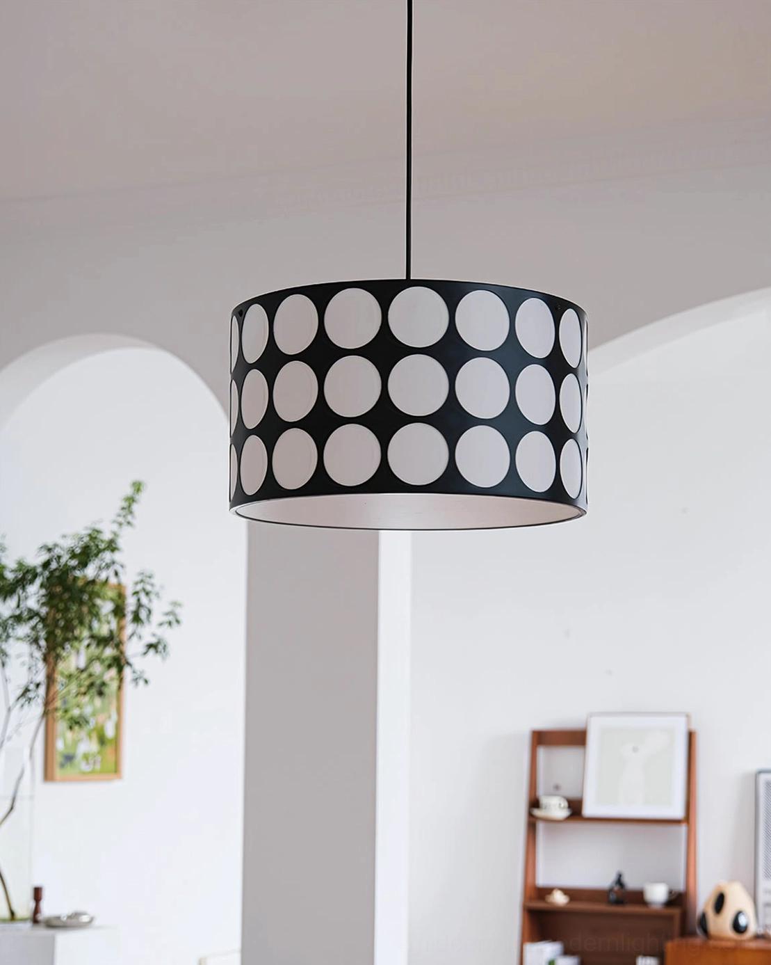 Polka dot pendant lamp in contemporary living room setting with modern furniture styling