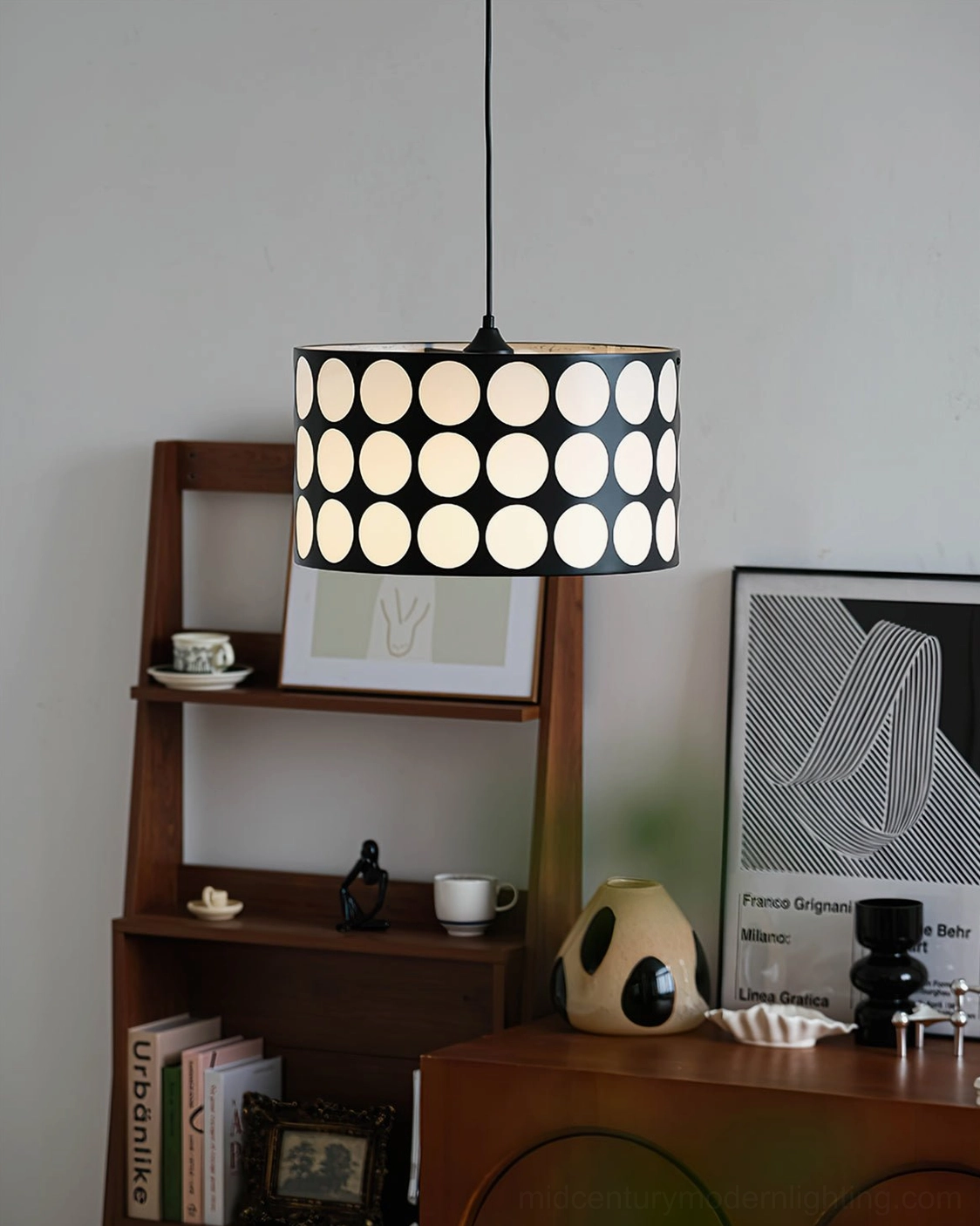 Polka dot pendant lamp displayed with wooden shelf and gallery wall art prints in home setting