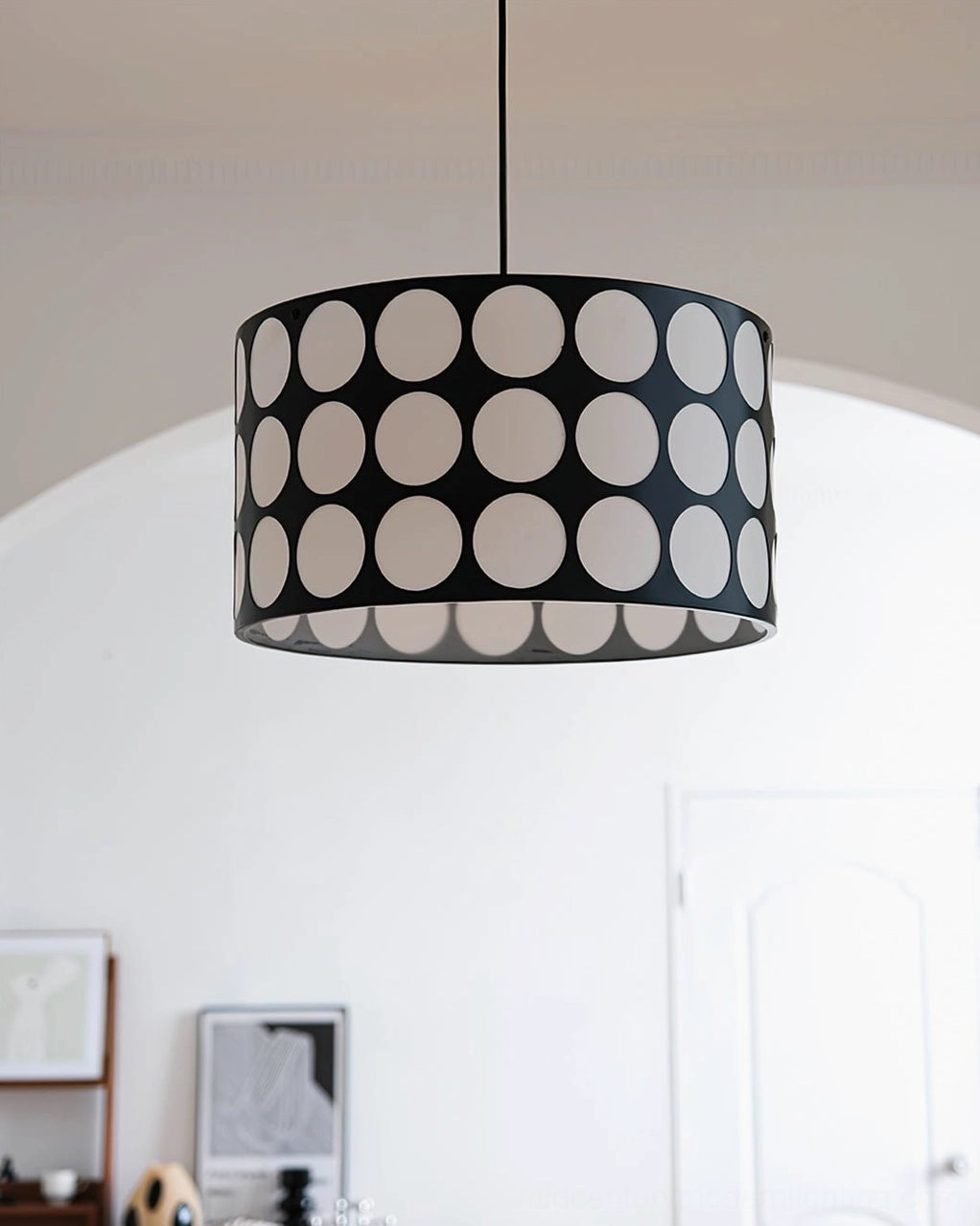 Black and white polka dot pendant lamp as focal point in mid-century modern home interior design