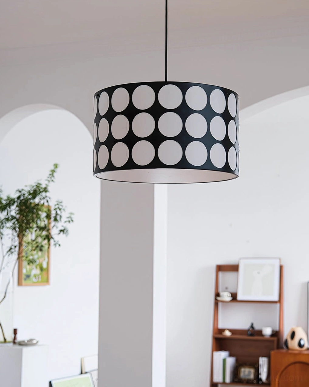 Polka dot pendant lamp side view against clean white wall background mid-century modern style