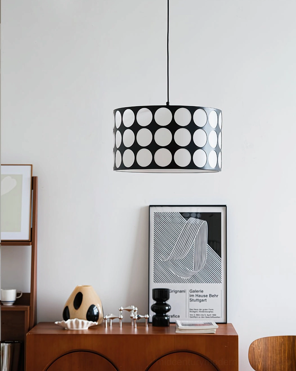 Polka dot pendant lamp hanging in vintage home study corner with wooden furniture and retro accessories