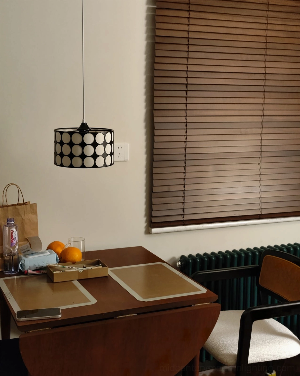 Polka dot pendant lamp in styled home setting paired with wooden accessories and vintage home decor