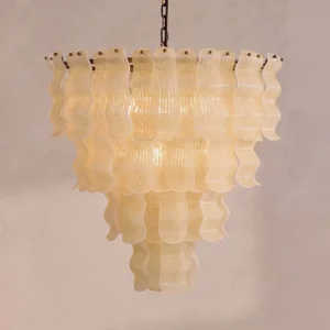 Close-up detail of Pollensa chandelier layered glass ribbons with graniglia texture and warm amber-beige tone