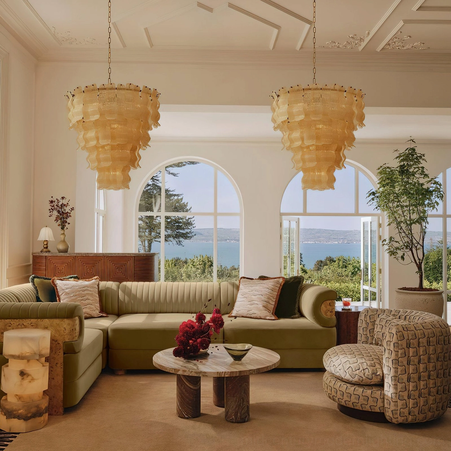 Pollensa textured wave chandelier installed in luxury coastal living room with lake view windows and vintage furniture