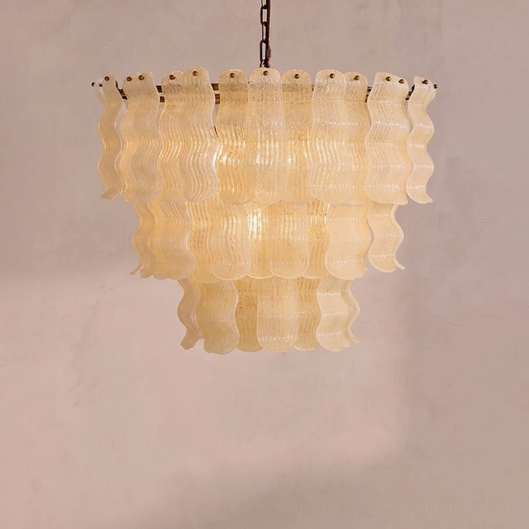 Front close-up view of Pollensa chandelier hand-poured glass tiers with off-white wavy structure and texture detail