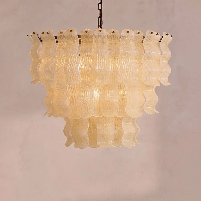 Three-quarter front view of Pollensa chandelier showing warm amber tone and detailed wavy glass panel construction