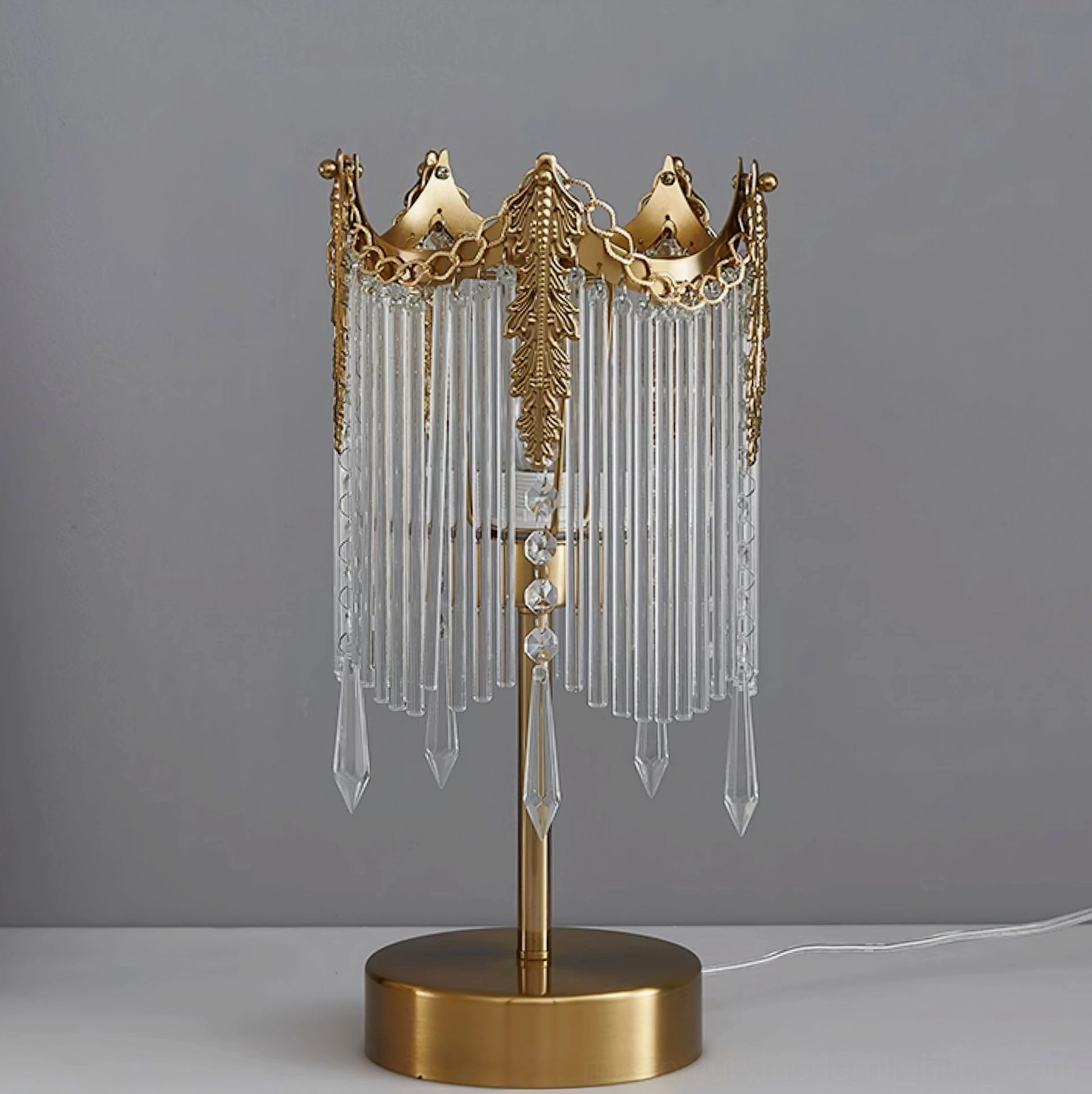 Popity crystal table lamp showing detailed brass frame and metal pole construction from front angle
