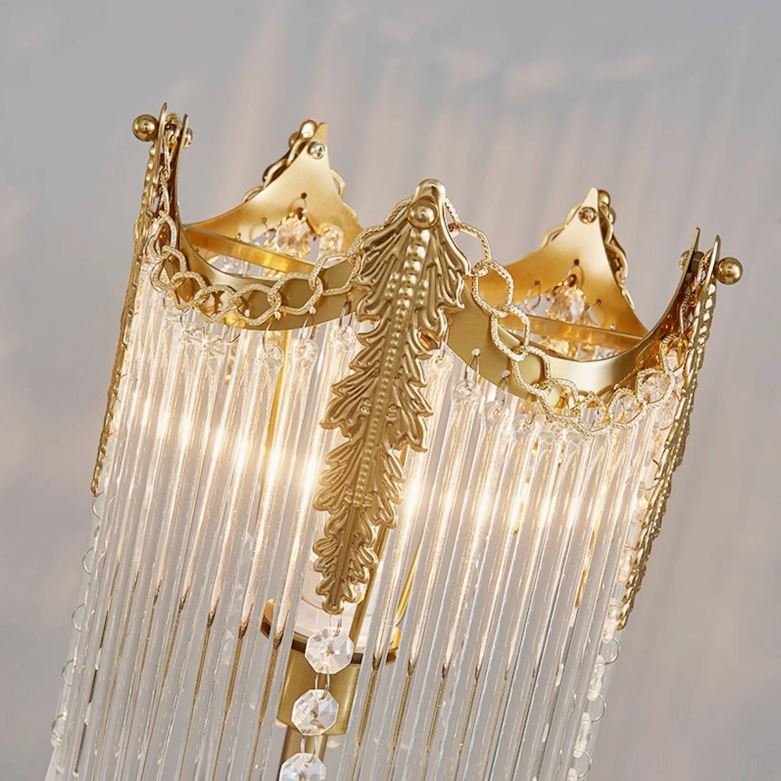 Overhead view of Popity lamp crown top showing ornate brass frame and crystal chain decorative elements