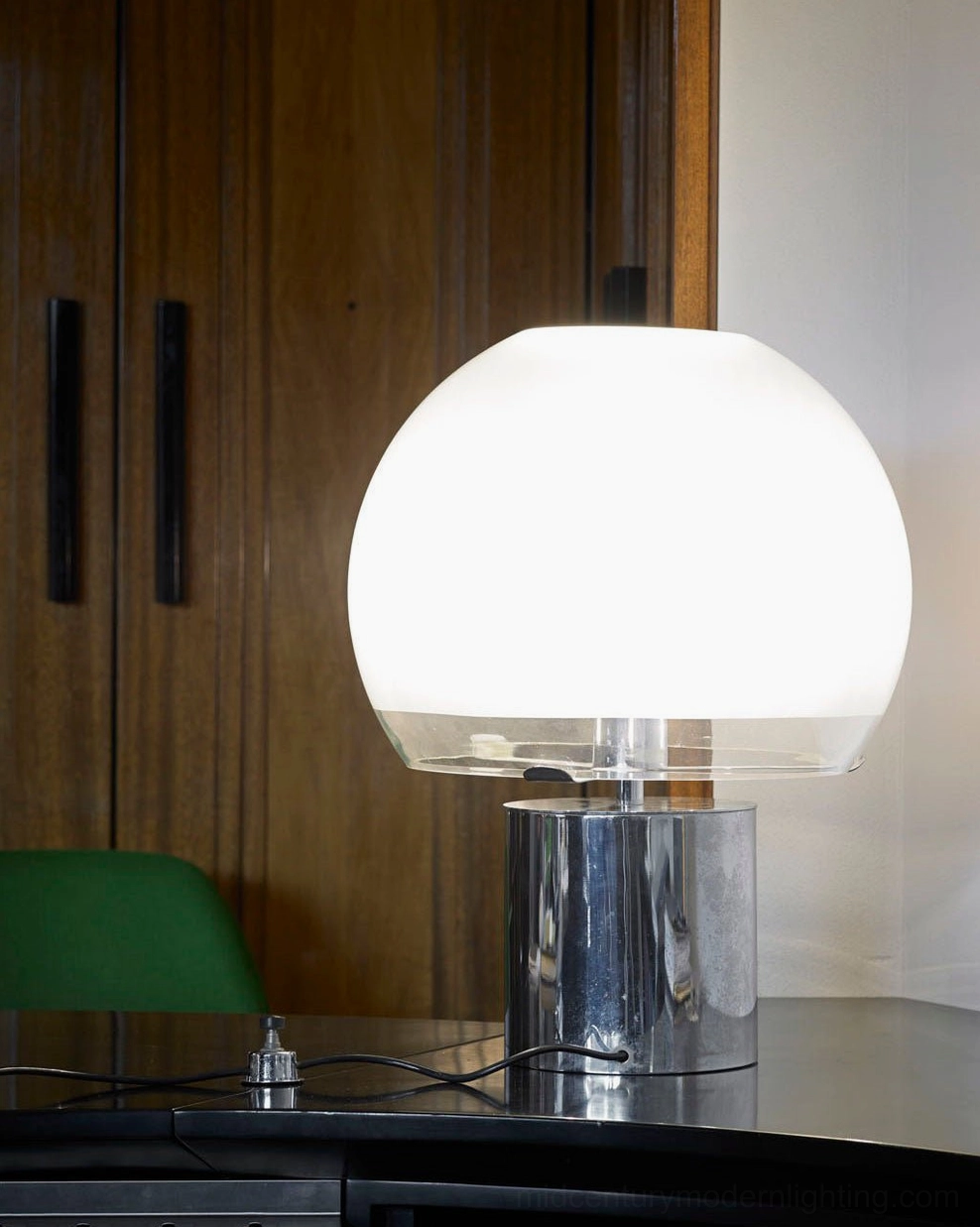 Porcino Orb Table Lamp with clear glass ring detail on home office desk, three-quarter front view