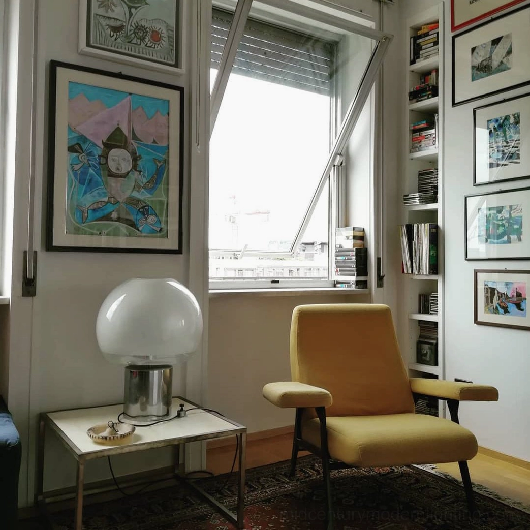 Porcino mid-century modern table lamp on metal side table in vintage living room corner interior setting
