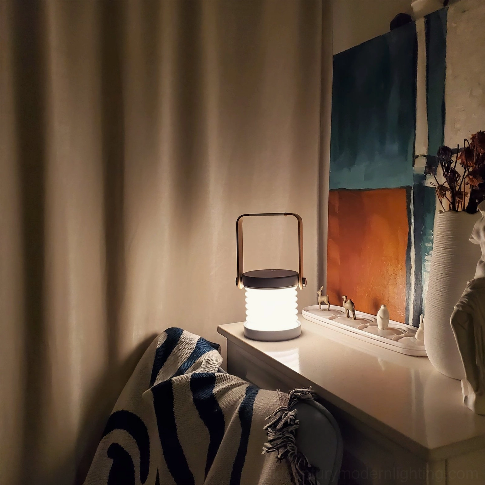 Compact portable lantern lamp on bedroom vanity desk, warm LED illumination in contemporary home interior setting