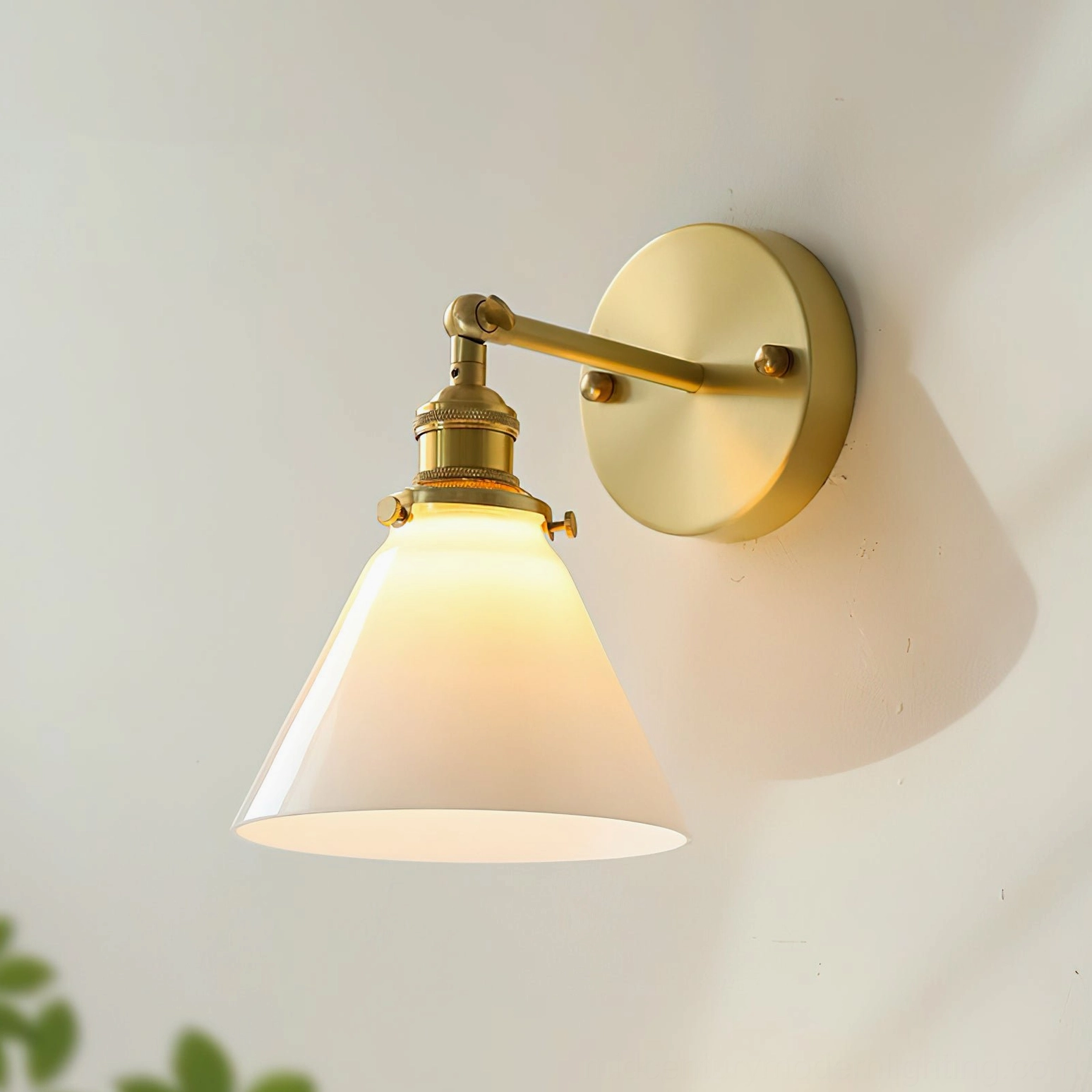 Portland mid-century wall sconce illuminated with warm light, showing brass hardware and industrial design elements