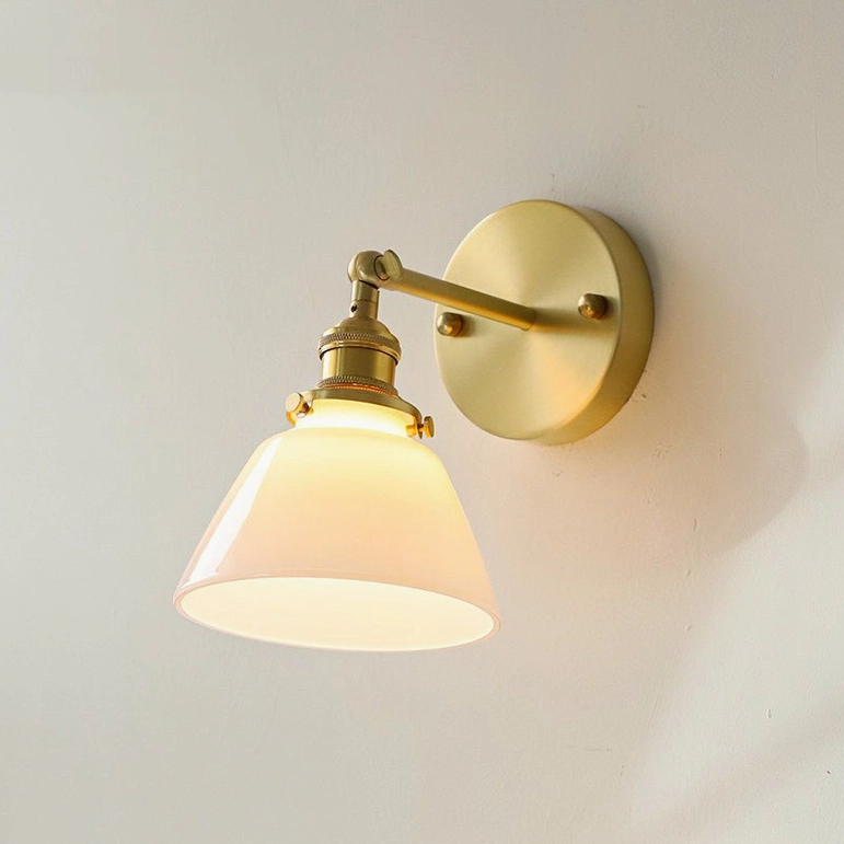 Portland model A mid-century modern brass wall sconce, front three-quarter view in studio setting