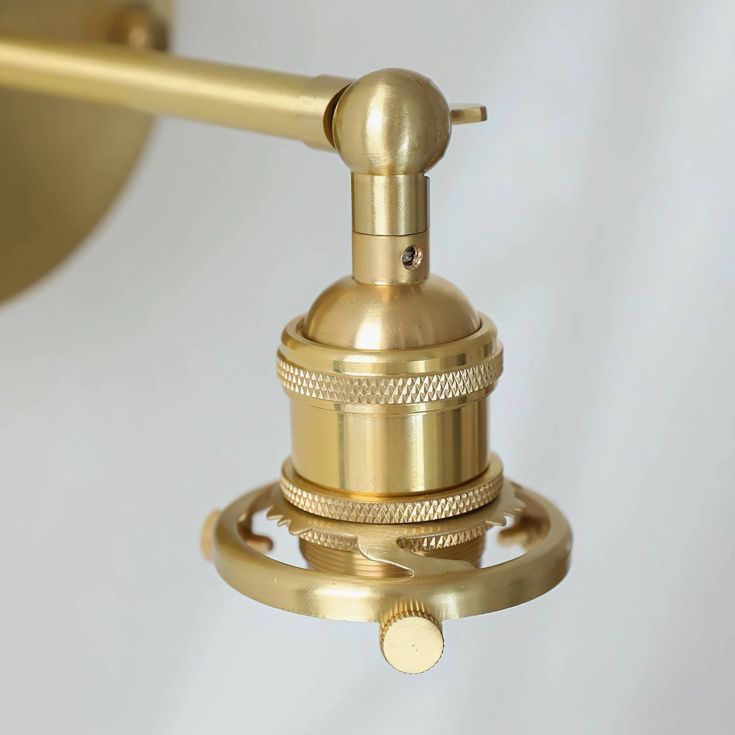 Portland vintage industrial wall sconce with articulated swivel joint, showing design flexibility and brass construction