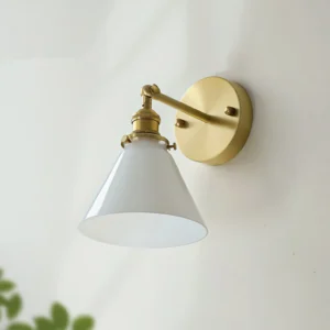 Mid-century modern Portland wall sconce mounted indoors with green foliage backdrop, side three-quarter angle view