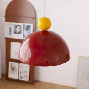 Burgundy red dome pendant lamp with yellow brass accent suspended in retro interior display