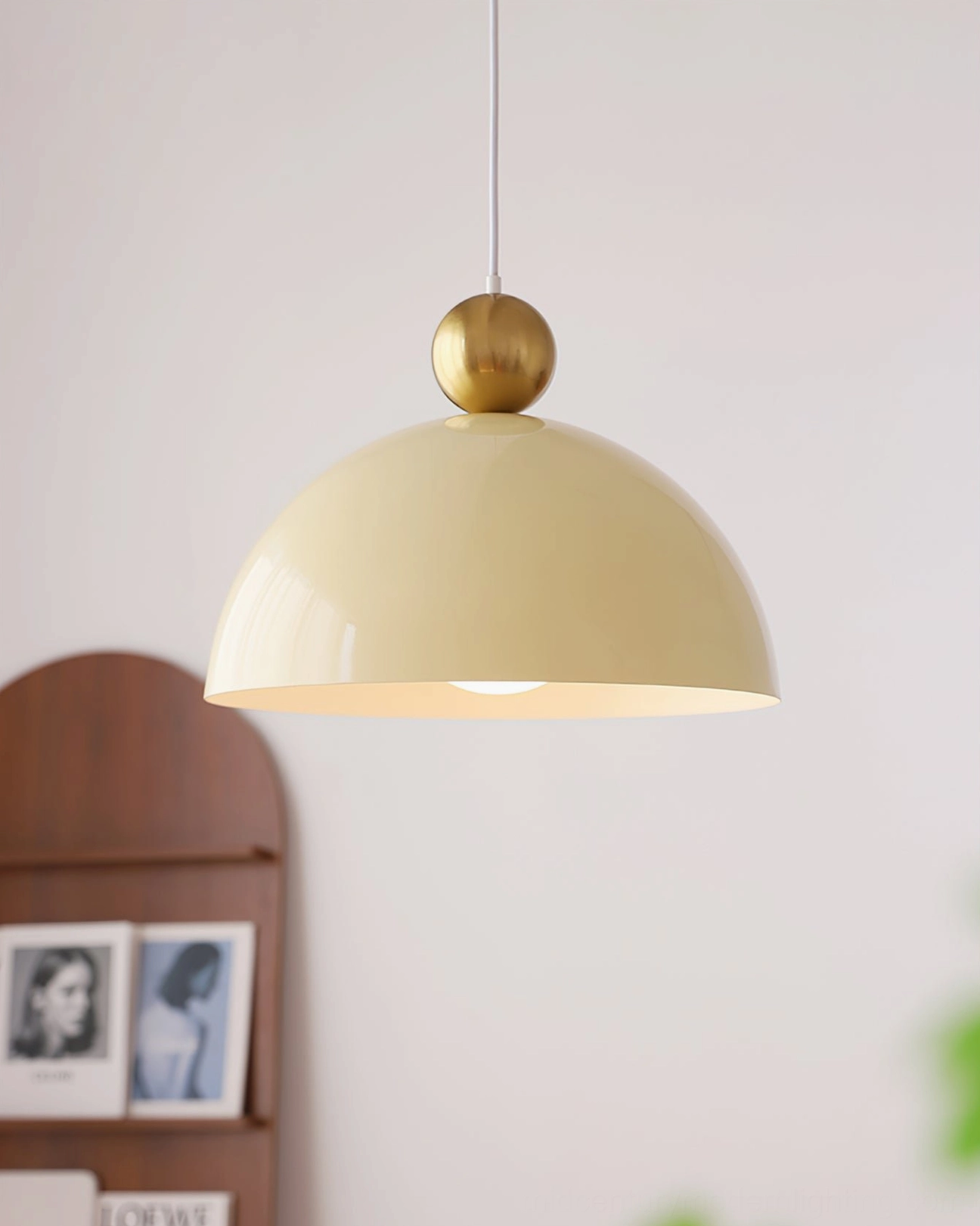 Cream white dome pendant lamp with brass spherical hardware - side view hanging installation