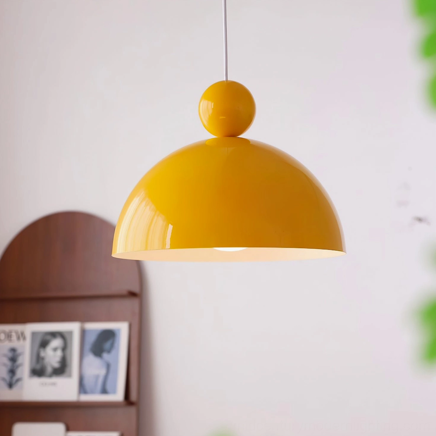 Mustard yellow glossy dome pendant lamp with brass top accent in retro home display