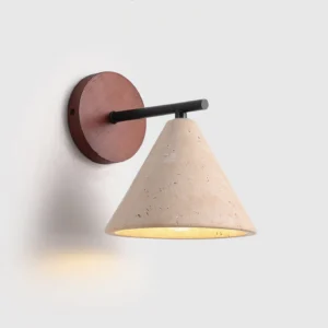 Possio wall sconce illuminated, demonstrating warm ambient glow diffused through travertine stone in minimalist setting