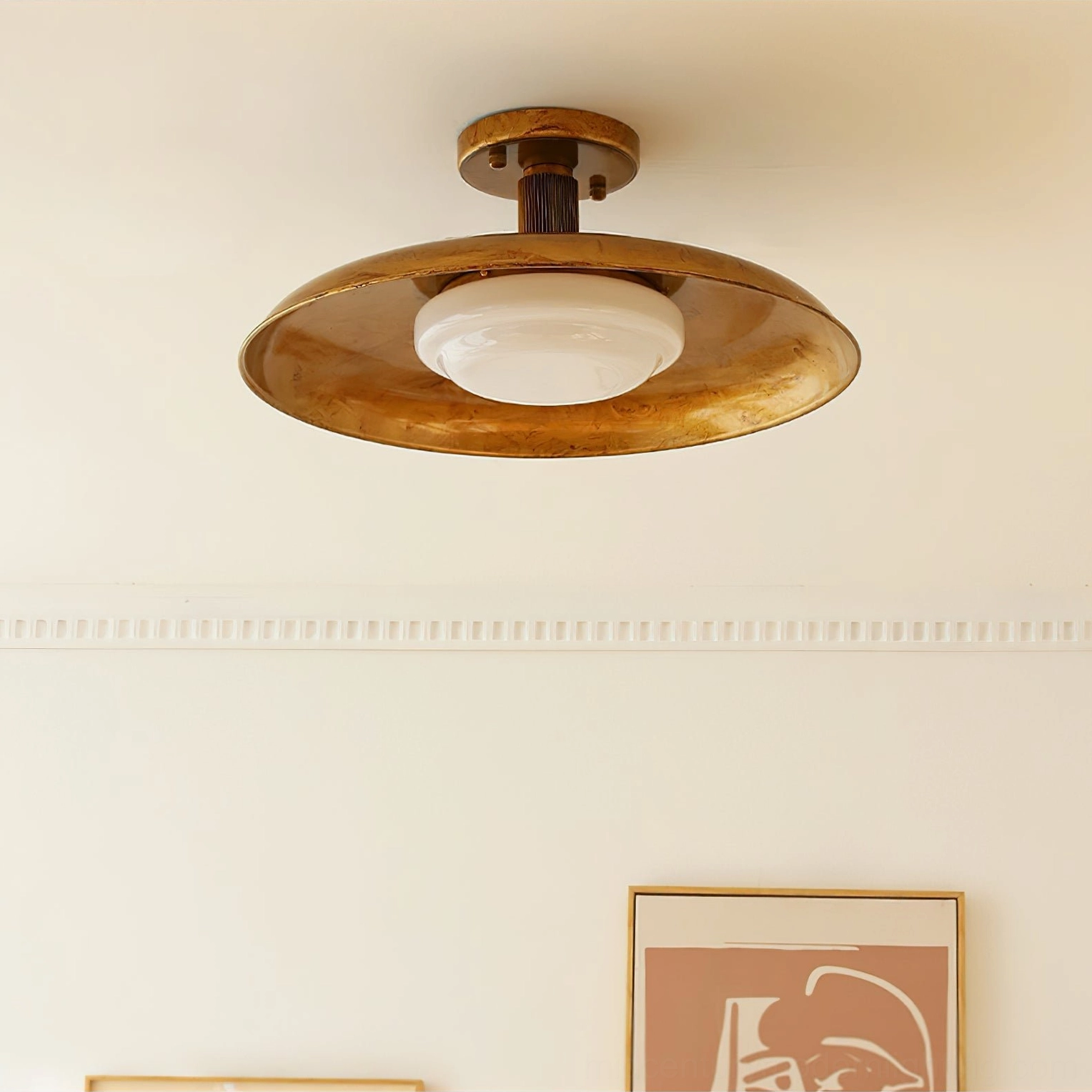 Brass pot-lid ceiling fixture with milky glass diffuser mounted on ceiling, unlit studio view with interior styling