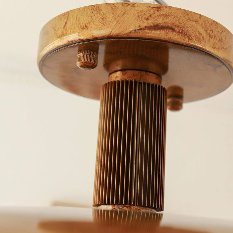 Close-up detail of ribbed brass mounting stem and hardware of vintage pot-lid ceiling light
